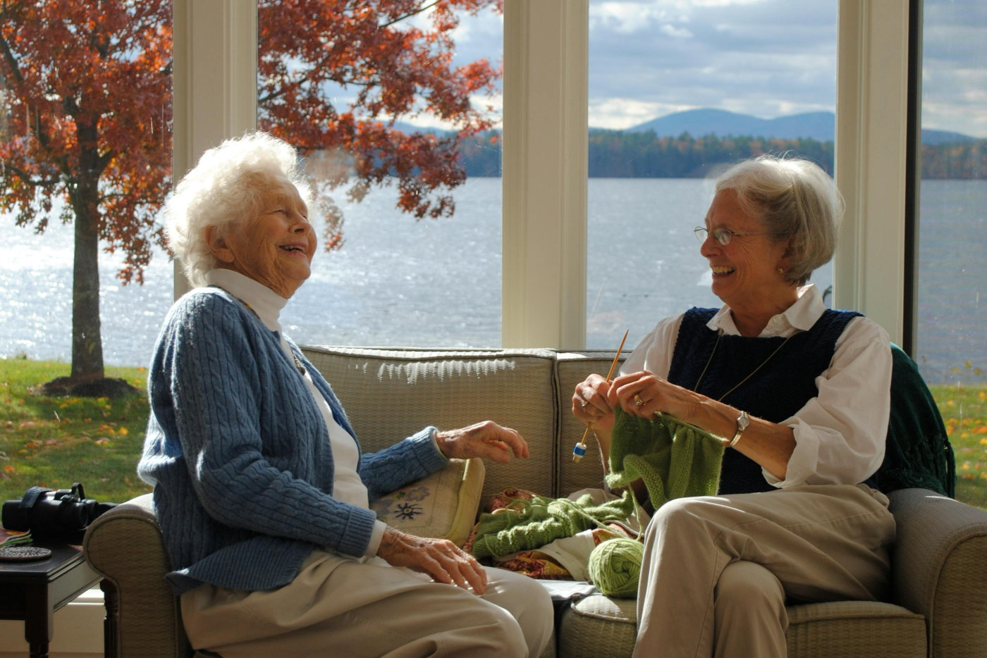 Elderly Woman Sitting on Sofa While Having a Conversation